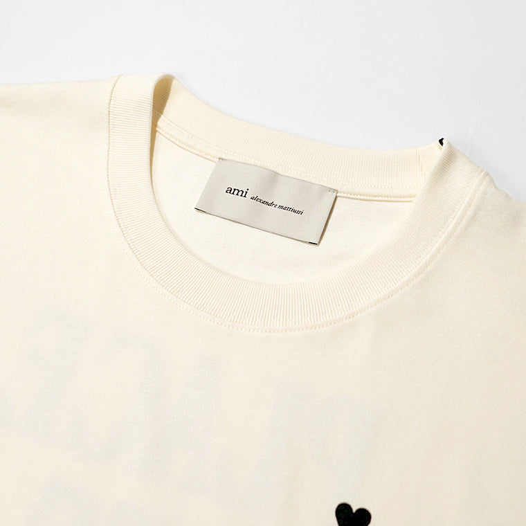 【2026SS SUMMER SALE】AMI メンズ Tシャツ AMI DE COEUR UTS387 726 BLANC CREME ホワイトクリーム 136